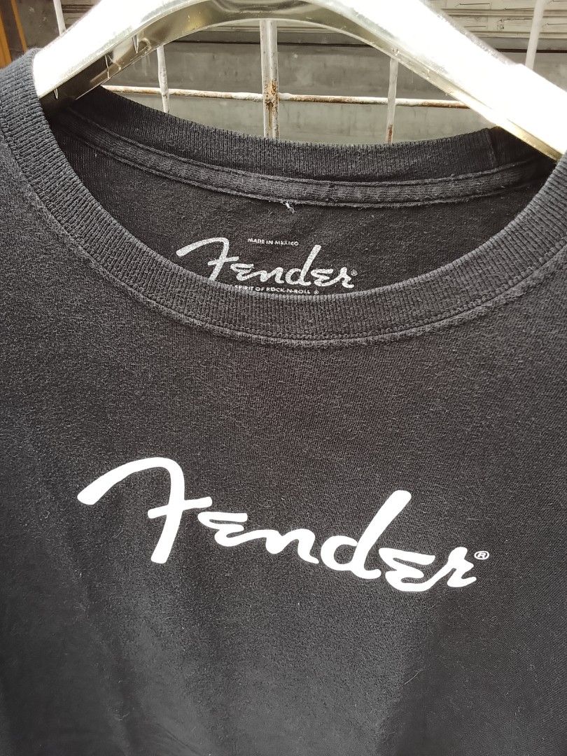 Black Fender T-Shirt Size L (Category: Tshirts & Polo Shirts ) located in Manila. Submitted by newage.vintage (Listing ID 1444964175, Image 2). Description: - Classic black Fender t-shirt - Features iconic Fender logo on the front - Made from 100% preshrunk cotton - Tagged as size L - Ideal for music lovers and Fender enthusiasts - Easy to wear and care for.