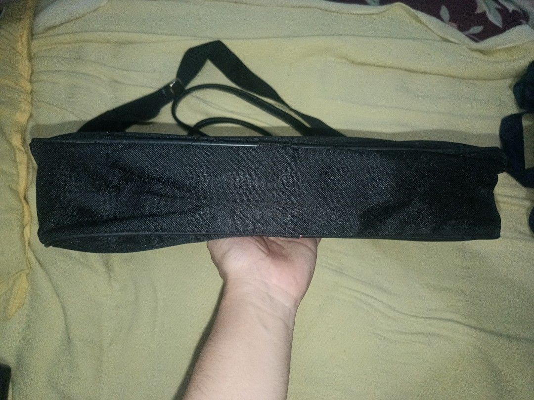 Black Laptop Bag with Shoulder Strap (Category: Laptop Bags & Sleeves) located in Cebu City. Submitted by turuuru8992423 (Listing ID 1444970293, Image 3). Description: Professional Black Laptop Bag 📌 Material: Durable woven fabric exterior with a smooth interior lining. 📌 Condition: Pre-loved and in good functional condition. 📌 Highlights: Features both top carry handles and a detachable shoulder strap for versatile carrying options. 📌 Design