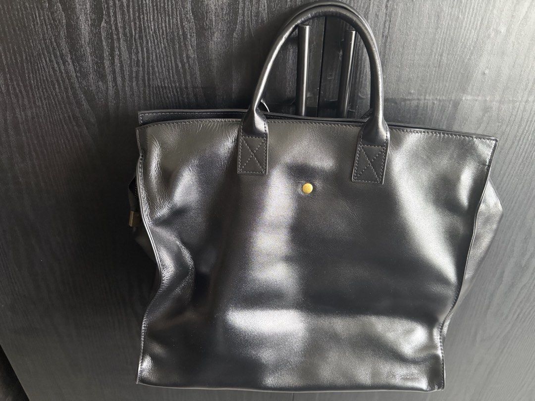 Black Leather Tote Bag with Shoulder Strap (Category: Tote Bags) located in Mandaluyong City. Submitted by bookmarkdown (Listing ID 1445027498, Image 2). Description: -Bought from Marikina Hub for 10k - Classic black leather tote bag - Front zippered pocket - Magnetic snap closure - Interior zippered pocket - Interior slip pocket - Adjustable shoulder strap - Gold hardware details - Spacious for daily essentials - Can fit 16in laptop.