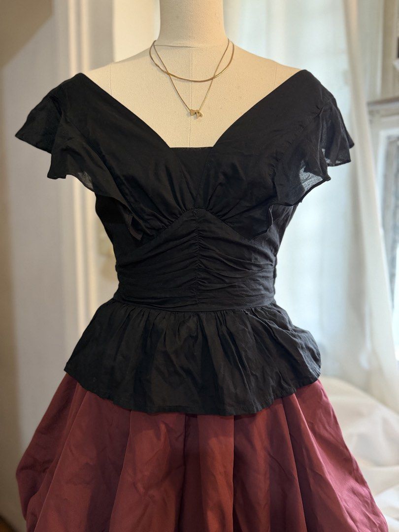 Black Ruffled V-Neck Peplum Top (Category: Sleeveless) located in Quezon City. Submitted by dlm03 (Listing ID 1444906991, Image 2). Description: - Elegant black peplum top - Features ruffled short sleeves - Flattering V-neckline with ruched bodice detail - Cinched waist for a defined silhouette - Versatile: pairs well with skirts or high-waisted pants - Ideal for night outs or special occasions.