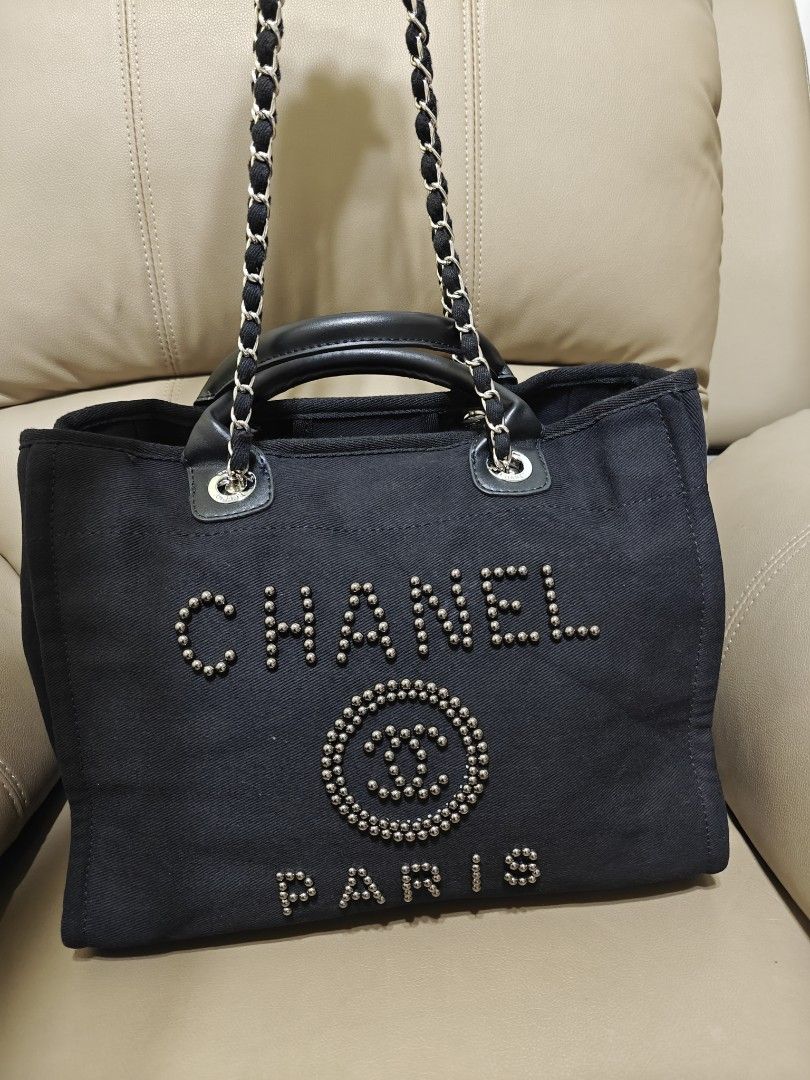 Chanel Black Canvas Studded Tote Bag (Category: Luxury Bags & Wallets) located in Pililla. Submitted by reginedomasig (Listing ID 1444919227, Image 3). Description: - Chanel black canvas tote bag - Embellished with stud details on the brand name and logo - Comfortable leather handles and stylish chain straps - Multiple interior compartments for organization - Ideal for everyday use and errands.