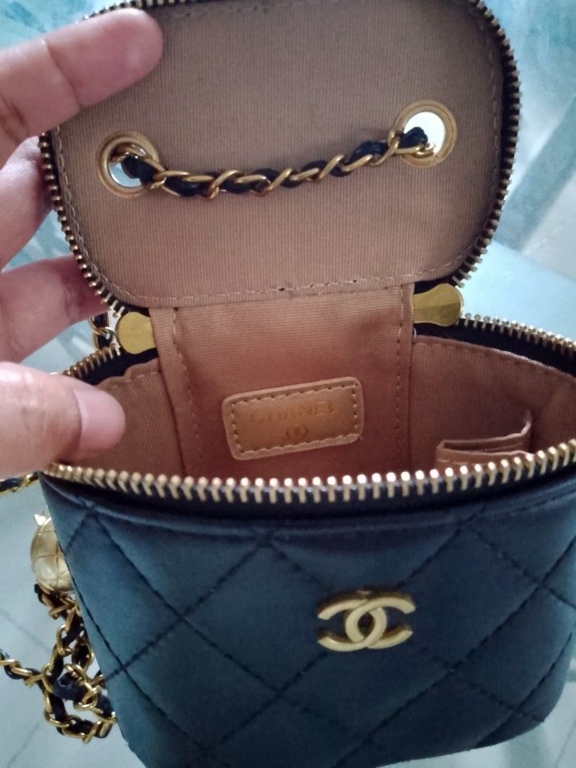 Chanel Black Quilted Vanity Case Bag with Chain (Category: Luxury Bags & Wallets) located in Manila. Submitted by badkiss_coffee26 (Listing ID 1444939047, Image 1). Description: - Black quilted vanity case bag - Gold hardware and chain strap - Zipper closure - Interior leather tag with Chanel logo - Comes with a cute ball charm - Ideal for carrying essentials.