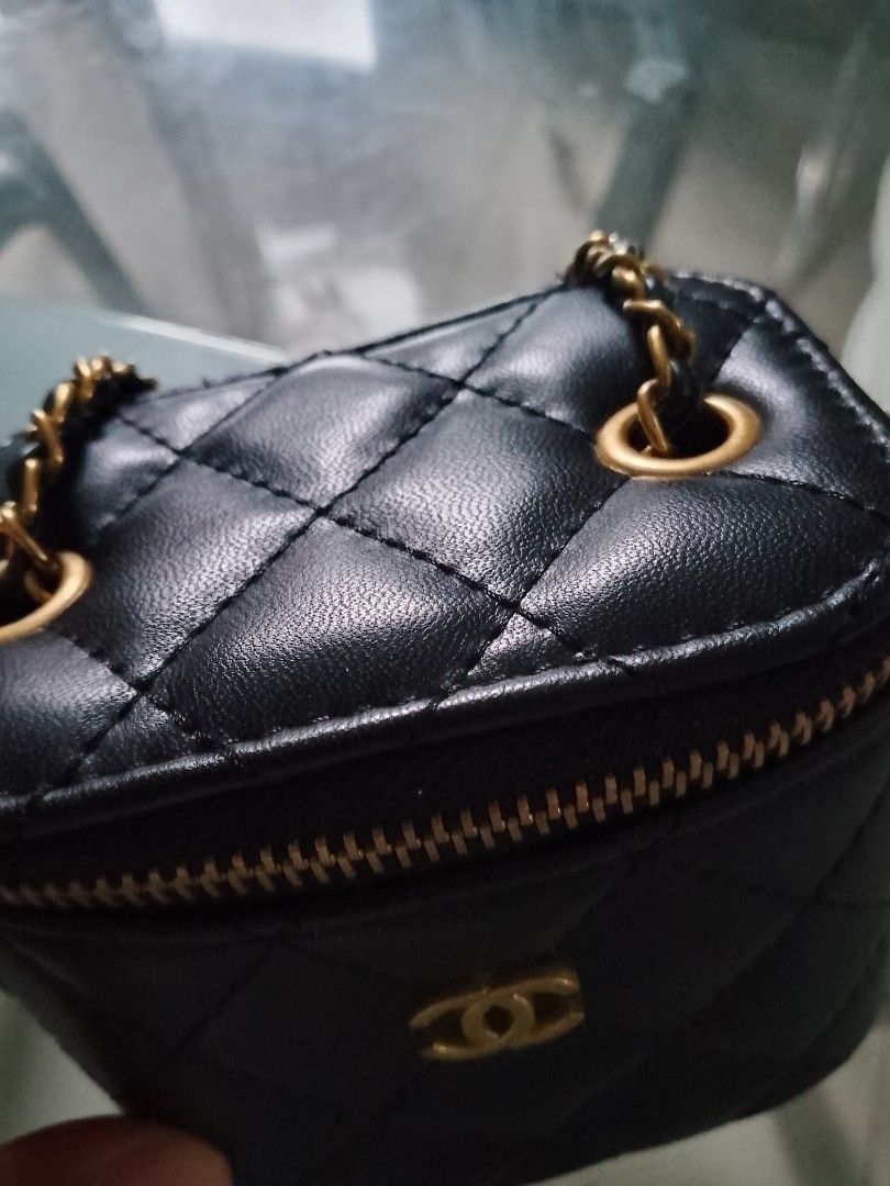 Chanel Black Quilted Vanity Case Bag with Chain (Category: Luxury Bags & Wallets) located in Manila. Submitted by badkiss_coffee26 (Listing ID 1444939047, Image 3). Description: - Black quilted vanity case bag - Gold hardware and chain strap - Zipper closure - Interior leather tag with Chanel logo - Comes with a cute ball charm - Ideal for carrying essentials.