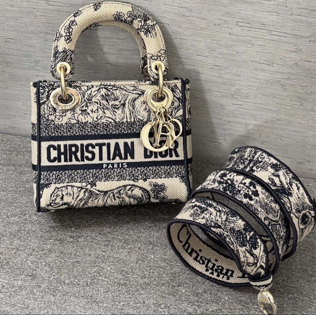 Christian Dior Lady Dior Mini D-Lite (Category: Luxury Bags & Wallets) located in Paranaque City. Submitted by Barrbiee (Listing ID 1444984315, Image 1). Description: - Authentic Christian Dior Mini Lady Dior D-lite Bag -Lightly used -with entrupy - Unique animal print design - Features 'Christian Dior Paris' lettering - Comes with a detachable strap for versatile wear - Elegant gold-tone hardware and charms - Ideal as a standout statement piece.