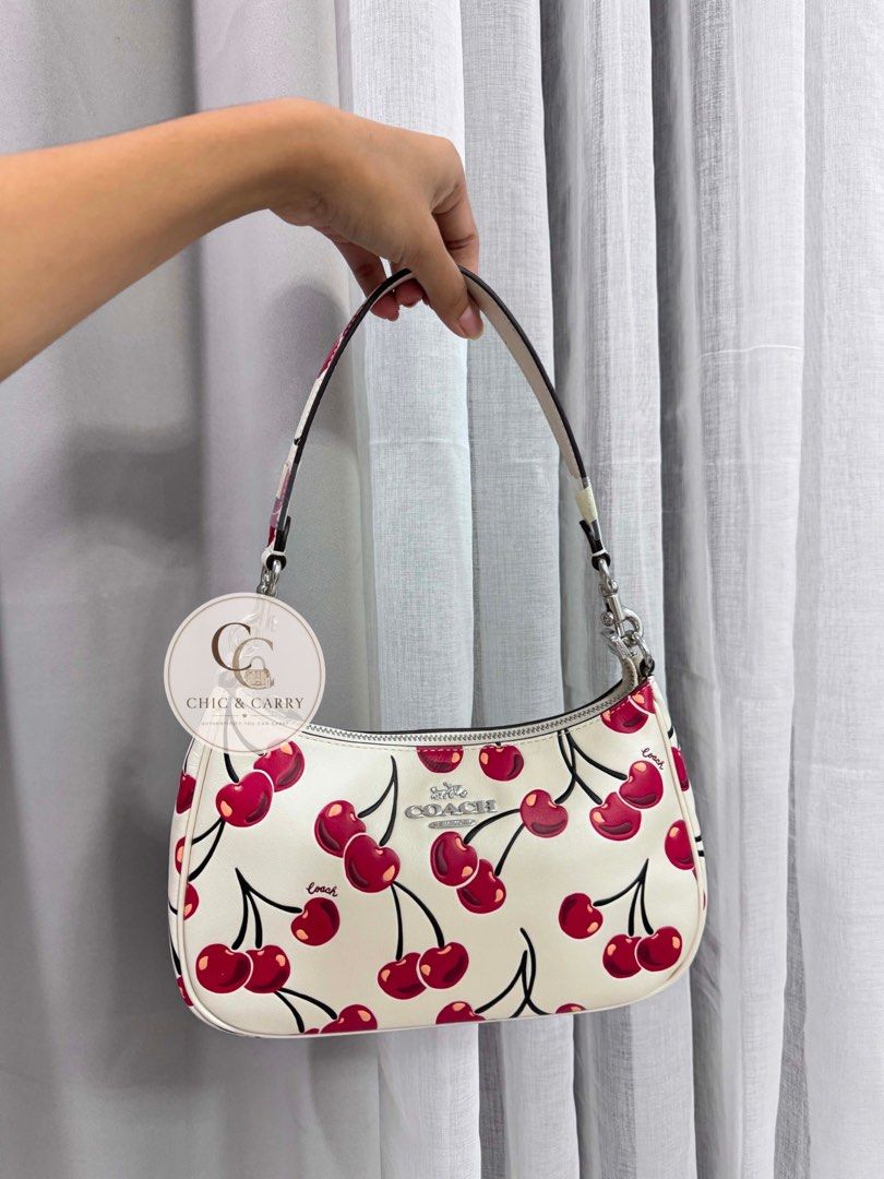 Coach Teri Shoulder Bag - Cherry Print (Category: Luxury Bags & Wallets) located in Quezon City. Submitted by chicandcarry.ph (Listing ID 1445036554, Image 1). Description: ✨ Brand New 🤎 Complete with 2 starps, Tag , Care Card & Polyplastic 📩 PM for more photos and inquiries .