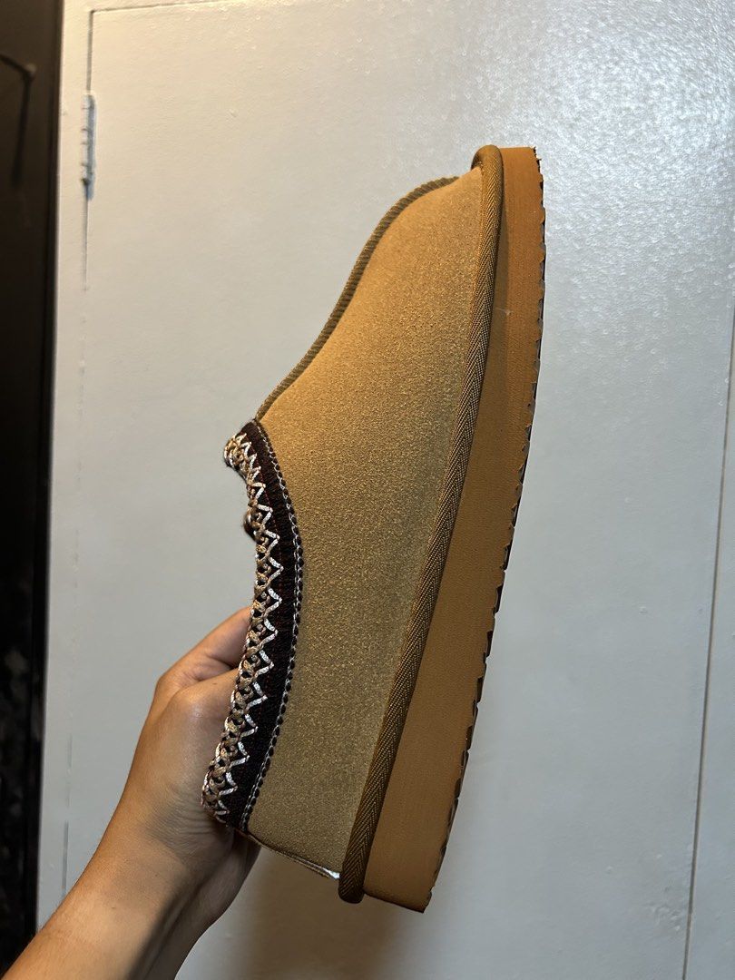 Cozy Brown Suede Slippers with Sherpa Lining (Category: Slippers & Slides) located in Manila. Submitted by popluxeph_ (Listing ID 1444940334, Image 2). Description: - Super comfy slippers perfect for lounging at home. - Brown suede exterior for a stylish look. - Warm and fluffy sherpa lining for ultimate comfort. - Sturdy, non-slip soles for safe indoor wear. - Decorative braided trim adds a nice touch. - Marked size 43..