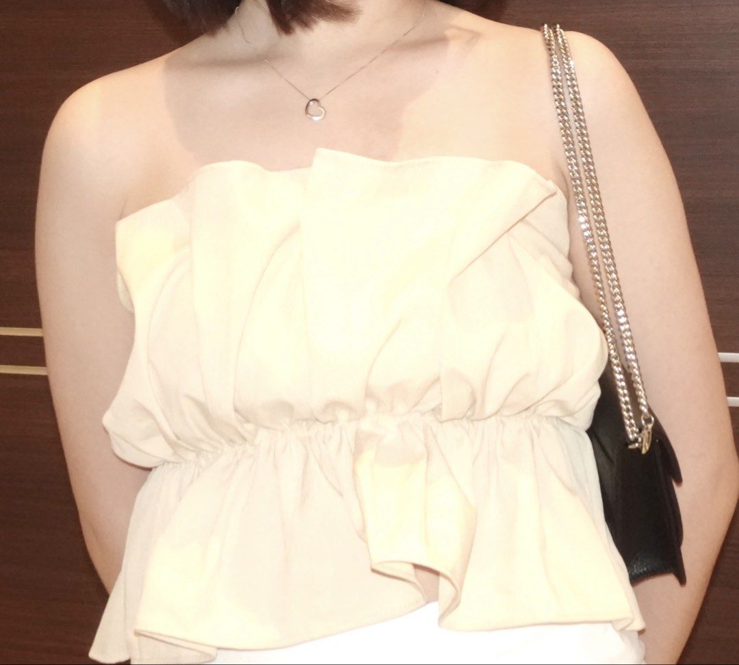 Cream Ruffle Strapless Tube Top Peplum (Category: Others Tops) located in Manila. Submitted by ria_25 (Listing ID 1444907792, Image 3). Description: - Cream colored strapless tube top - Ruffle detail along top and bottom hem - Peplum style - Estimated size: Small to Medium - Versatile for night out or casual wear - Pairs well with jeans or skirts (Worn once) .