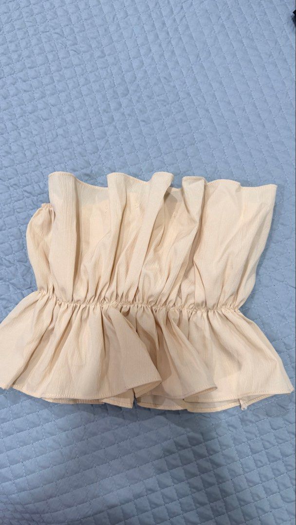 Cream Ruffle Strapless Tube Top Peplum (Category: Others Tops) located in Manila. Submitted by ria_25 (Listing ID 1444907792, Image 1). Description: - Cream colored strapless tube top - Ruffle detail along top and bottom hem - Peplum style - Estimated size: Small to Medium - Versatile for night out or casual wear - Pairs well with jeans or skirts (Worn once) .