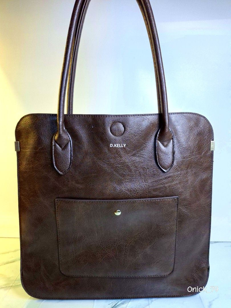 D. KELLY Brown Leather Tote Bag (Category: Tote Bags) located in Pasay City. Submitted by onick_79 (Listing ID 1444959418, Image 3). Description: The brand is D.KELLY, a Japanese fashion brand known for making stylish, highly functional everyday bags, business totes, and backpacks. The vast majority of D.KELLY's lineup is intentionally crafted from high-quality synthetic leather (PU) to keep the bags lightweight, affordable, water-resistant, and 