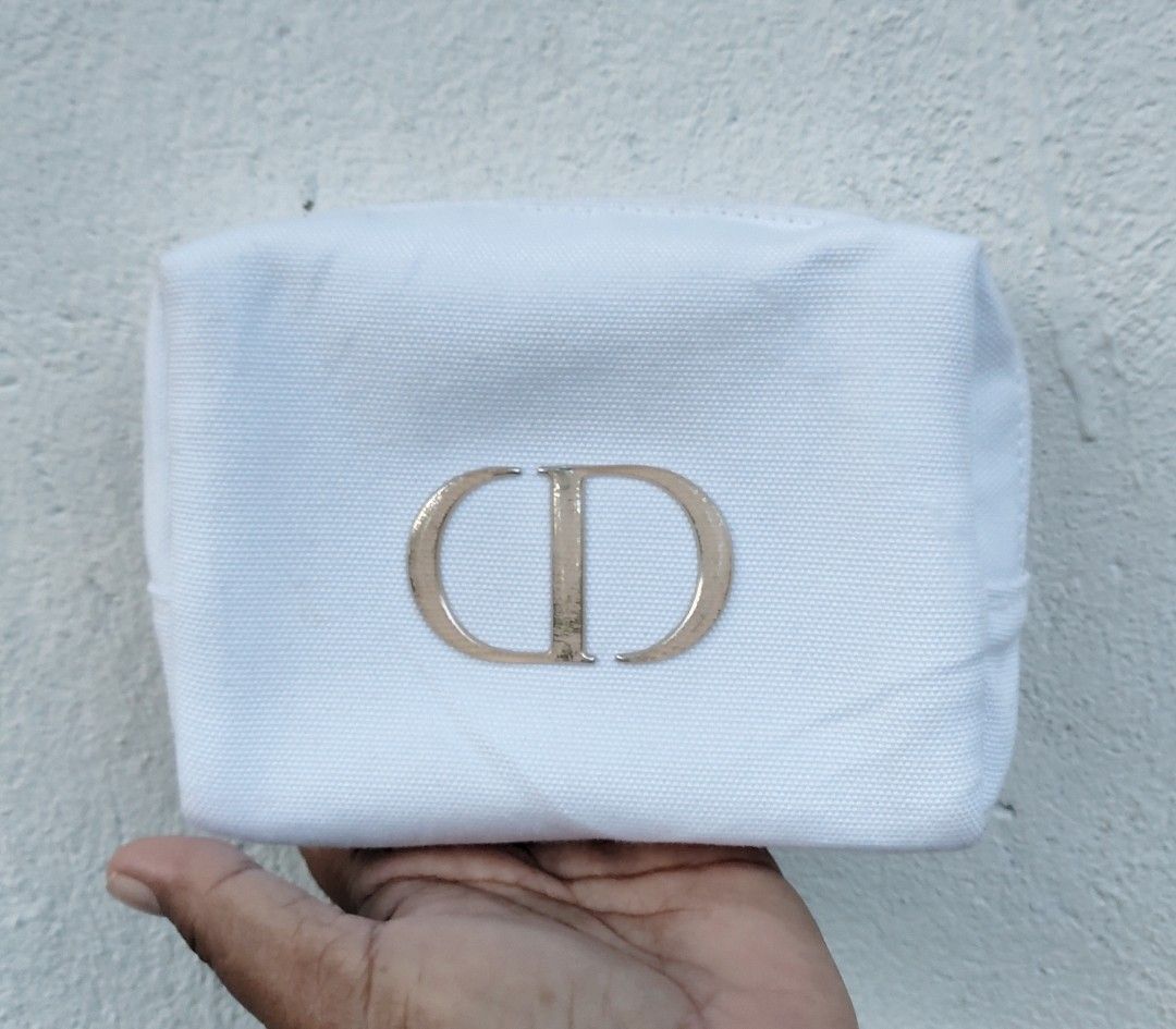 Dior CD Logo Cosmetic Bag Pouch (Category: Luxury Bags & Wallets) located in Lapu Lapu. Submitted by agnesapm_29813 (Listing ID 1444981767, Image 1). Description: - Authentic White Dior Pouch - Iconic CD Logo - Secure Zipper Closure - Ideal for Makeup or Travel Essentials - Clean Interior - Dimensions: width-6 inches, height-5 inches .