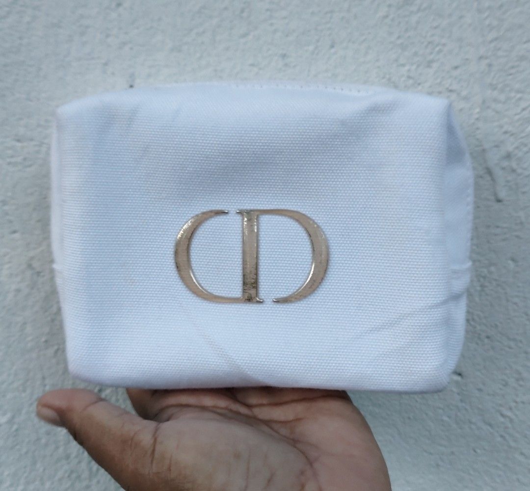 Dior CD Logo Cosmetic Bag Pouch (Category: Luxury Bags & Wallets) located in Lapu Lapu. Submitted by agnesapm_29813 (Listing ID 1444981767, Image 2). Description: - Authentic White Dior Pouch - Iconic CD Logo - Secure Zipper Closure - Ideal for Makeup or Travel Essentials - Clean Interior - Dimensions: width-6 inches, height-5 inches .