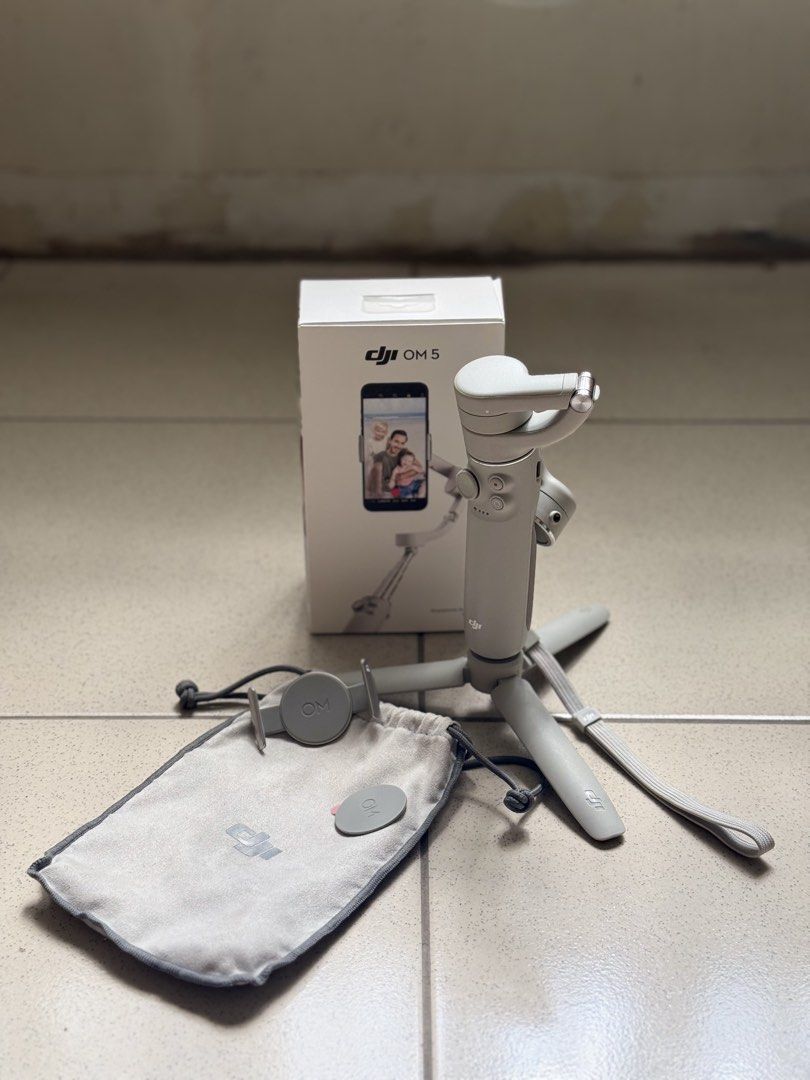 DJI OM 5 Smartphone Gimbal Stabilizer (Category: Gimbals & Stabilizers ) located in Bongabon. Submitted by yvannee (Listing ID 1444915469, Image 3). Description: - DJI OM 5 Gimbal for incredibly smooth phone videos. - Comes with tripod base for stable shots. - Includes a convenient carrying pouch. - Features a magnetic phone clamp for quick attachment. - Original box included. - Ideal for vlogging and capturing stable footage anywhere. - Simple s
