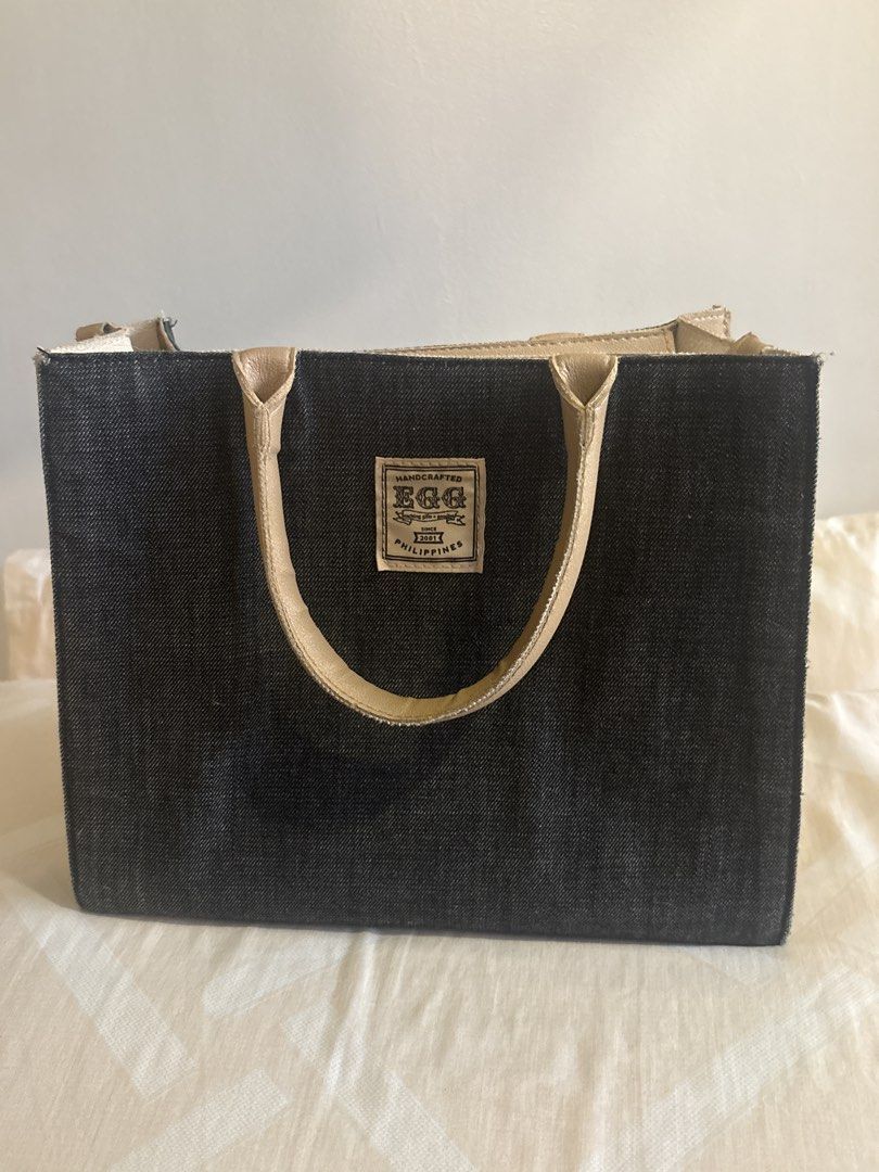 EGG Denim Tote Bag w strap (Category: Tote Bags) located in Manila. Submitted by esstarita (Listing ID 1444934634, Image 1). Description: - Chic denim tote bag - Accented with tan leather details - Features a small logo patch on the front - Tan leather handles - Structured, classic shape - Ideal for everyday carry - Proudly made in the Philippines.