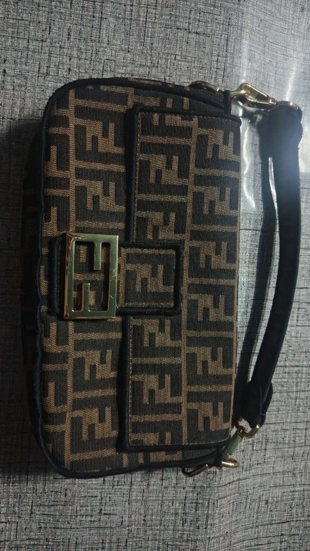 Fendi Baguette Monogram Canvas Shoulder Bag (Category: Luxury Bags & Wallets) located in Makati City. Submitted by macdwyneki84361 (Listing ID 1444968833, Image 1). Description: - Authentic Fendi Baguette Bag - Classic Zucca Monogram Canvas - Gold Hardware with Fendi Logo - Interior "Made in Italy" and "Baguette" Labels - Visible Serial Number Inside - Adjustable Strap - Ideal for Everyday Use.