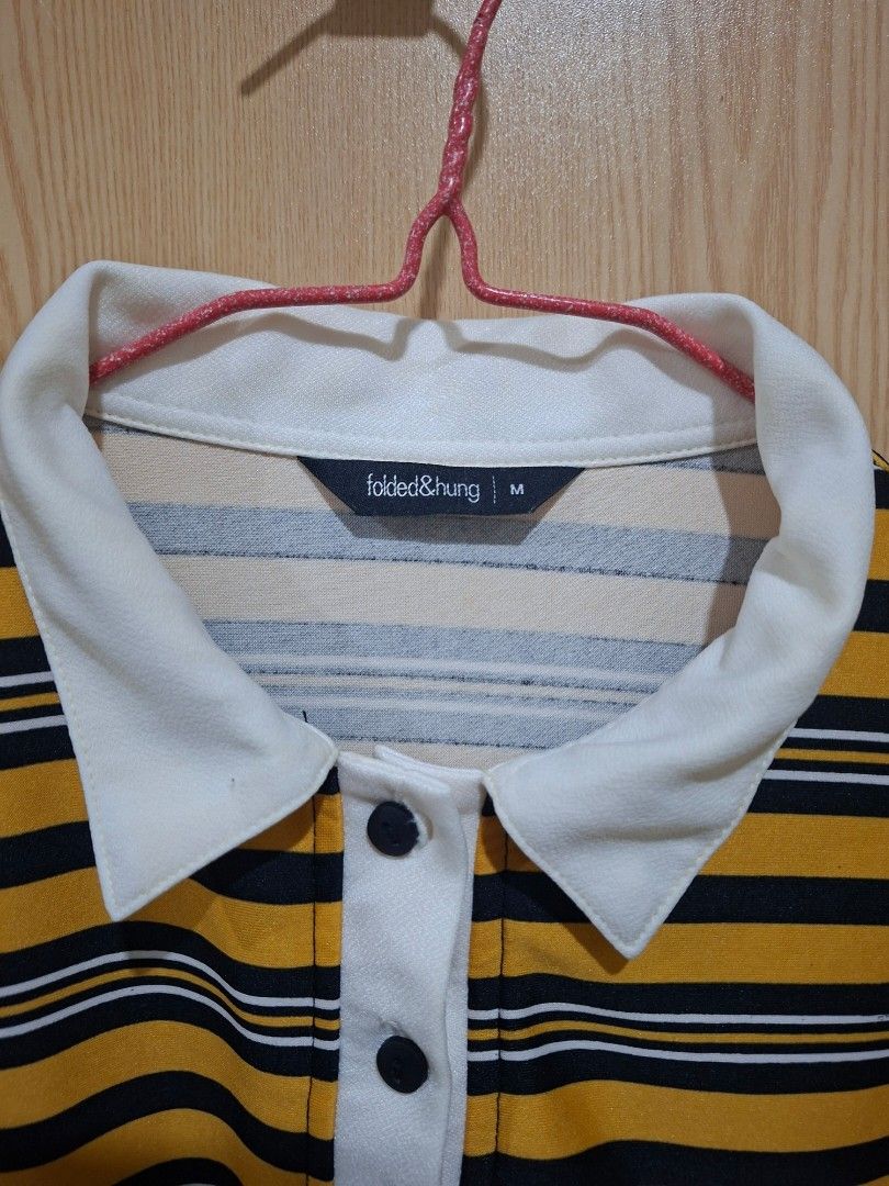 Folded & Hung Striped Polo Shirt (Category: Tshirts & Polo Shirts ) located in Santa Barbara. Submitted by hotarunn (Listing ID 1445039414, Image 2). Description: - Brand: Folded & Hung - Color: Yellow and black stripes - Style: Long sleeve polo shirt - Features: White collar and button placket - Size: Medium (M) - Occasion: Casual wear.
