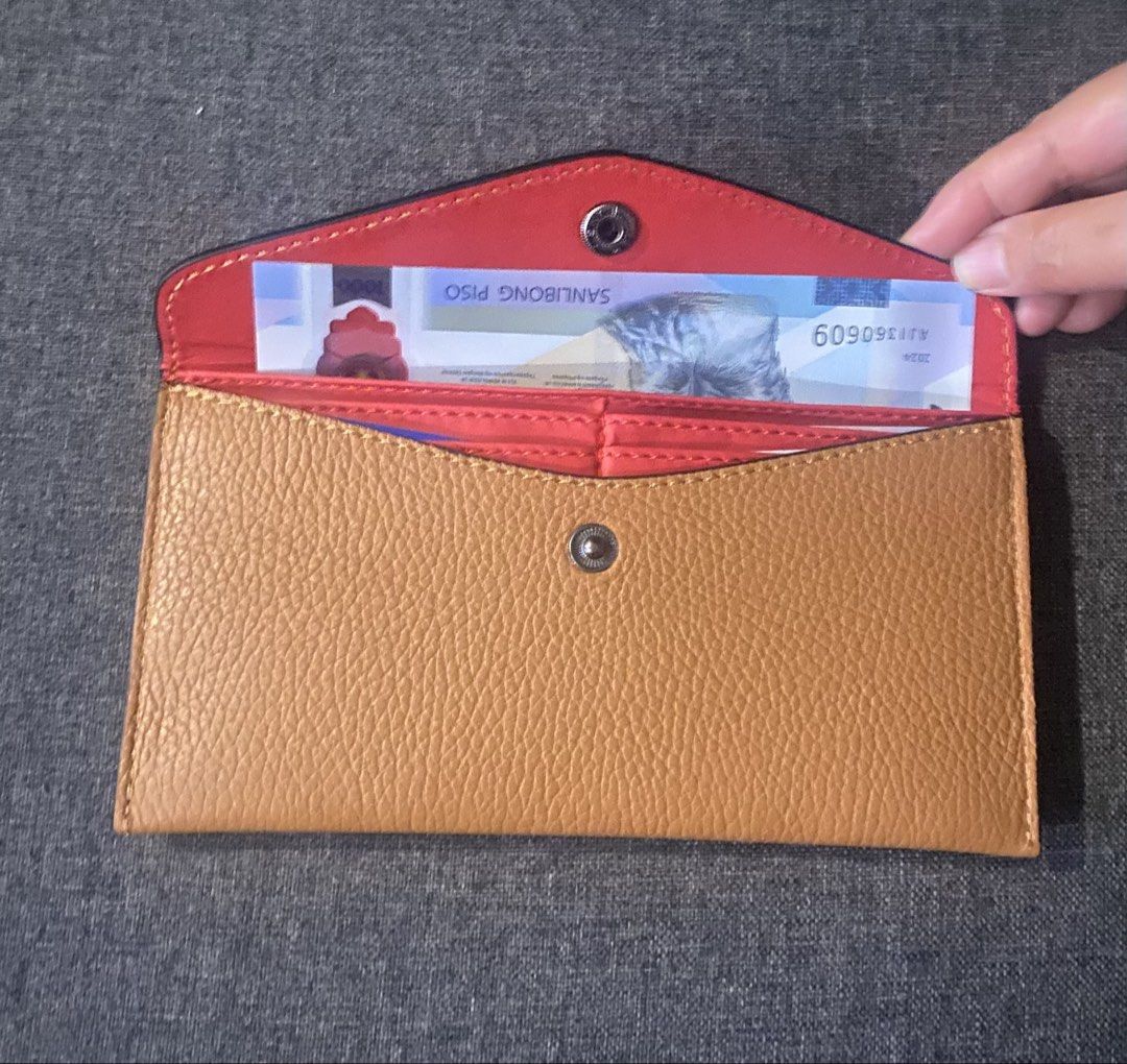 Genuine Leather Envelope Wallet Made in Italy (Category: Wallets & Card holders) located in Manila. Submitted by jrprelovedshop (Listing ID 1445032091, Image 3). Description: 👜 Minimalist Leather Envelope Wallet ✨ Chic & functional everyday wallet Perfect for those who love clean, minimalist style with a pop of color inside 💛❤️ - Genuine Italian leather - Tan exterior with a vibrant coral interior - Secure snap closure - Ample space for cards a