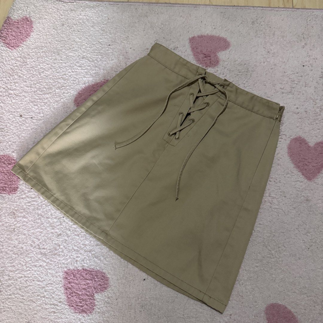 GU Khaki Lace-Up Front Mini Skirt (Category: Skirts) located in Marikina City. Submitted by prelovedsms (Listing ID 1444909115, Image 1). Description: Cute khaki mini skirt with front lace-up detail and side zipper. Issue: needs repair (please see last photo) Length: 16 inches Waist: 26 Height: 5’3 .