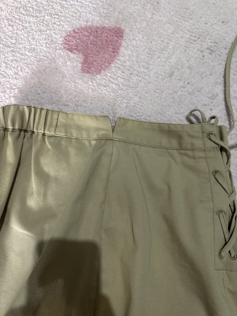 GU Khaki Lace-Up Front Mini Skirt (Category: Skirts) located in Marikina City. Submitted by prelovedsms (Listing ID 1444909115, Image 3). Description: Cute khaki mini skirt with front lace-up detail and side zipper. Issue: needs repair (please see last photo) Length: 16 inches Waist: 26 Height: 5’3 .