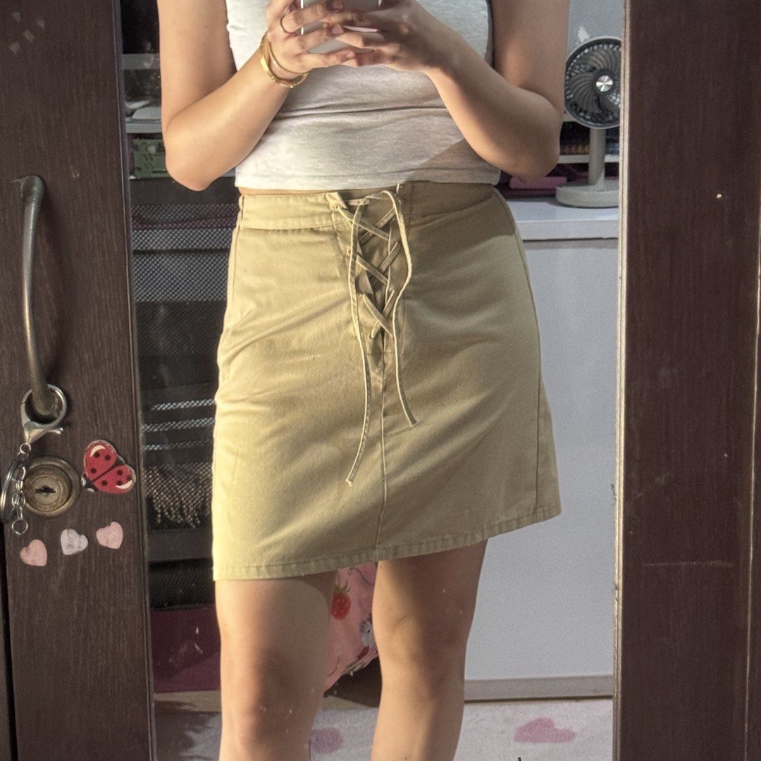 GU Khaki Lace-Up Front Mini Skirt (Category: Skirts) located in Marikina City. Submitted by prelovedsms (Listing ID 1444909115, Image 2). Description: Cute khaki mini skirt with front lace-up detail and side zipper. Issue: needs repair (please see last photo) Length: 16 inches Waist: 26 Height: 5’3 .