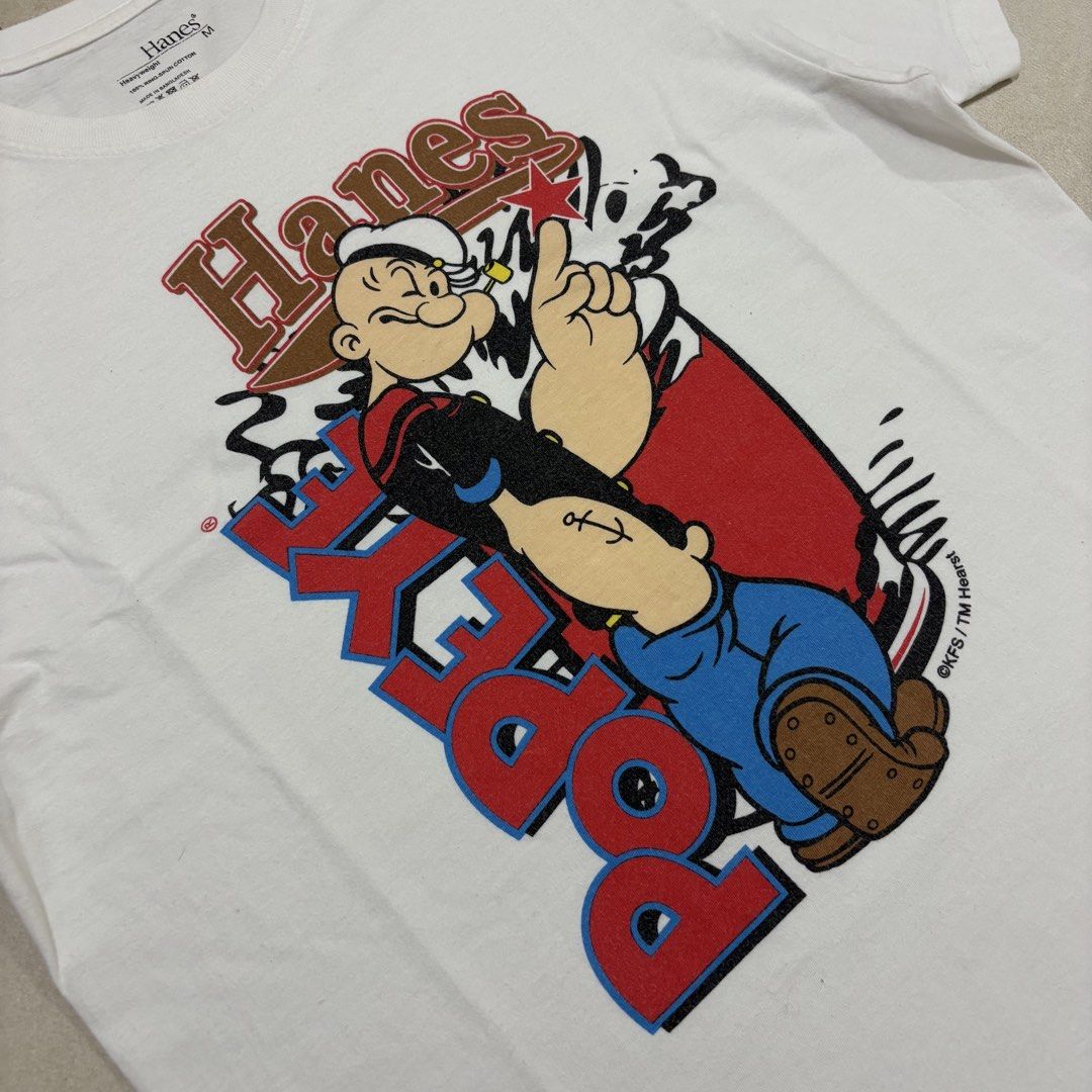 Hanes Popeye Graphic T-Shirt (Category: Tshirts & Polo Shirts ) located in Quezon City. Submitted by grailph (Listing ID 1444972950, Image 2). Description: - White Hanes T-Shirt - Size: Medium - Dimensions 19.5”x27.5” - Features Popeye graphic print and Hanes logo - Material: Heavyweight, 100% ring-spun cotton - Comfortable and durable - Ideal for Popeye fans.