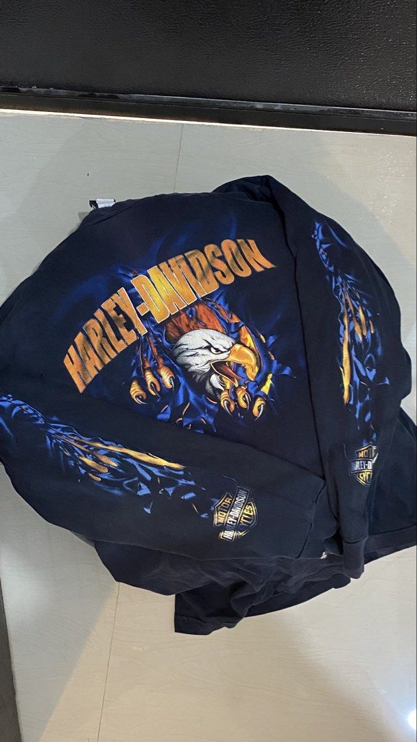 Harley-Davidson Long Sleeve T-Shirt Eagle Graphic (Category: Tshirts & Polo Shirts ) located in Porac. Submitted by moethrifter (Listing ID 1444948407, Image 3). Description: - Navy blue long sleeve t-shirt - Ripped effect graphic on front: eagle and flames - Back text: 'Barnes Harley-Davidson Langley, BC Canada' - Comfortable cotton material - Perfect for Harley-Davidson fans.