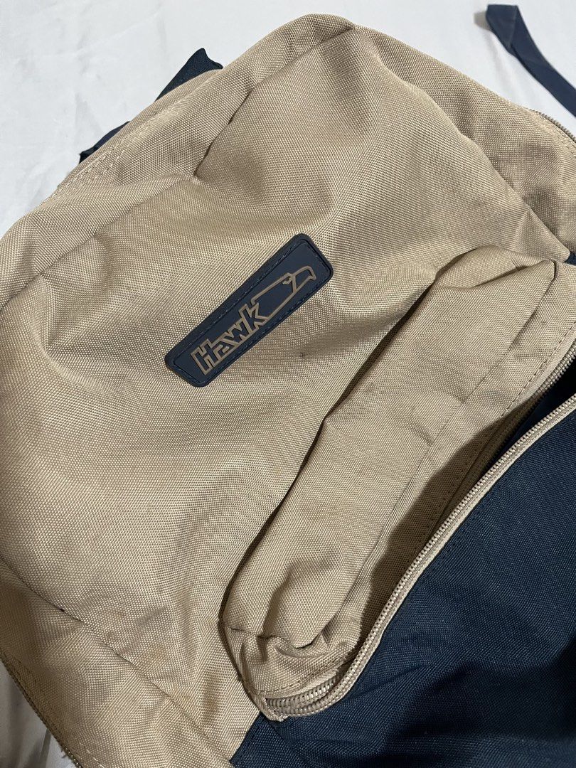 Hawk Backpack Tan and Navy Blue (Category: Backpacks) located in Manila. Submitted by p1nkbaddi3 (Listing ID 1444995690, Image 3). Description: Needs Cleaning only - Classic Hawk backpack - Tan and navy blue colorway - Two main compartments - Front zip pocket - Adjustable shoulder straps - Ideal for school or everyday use - Shows some signs of wear, but still functional 📍Location: Valenzuela City 💰Payment Method: Payment first via Gcash or bank