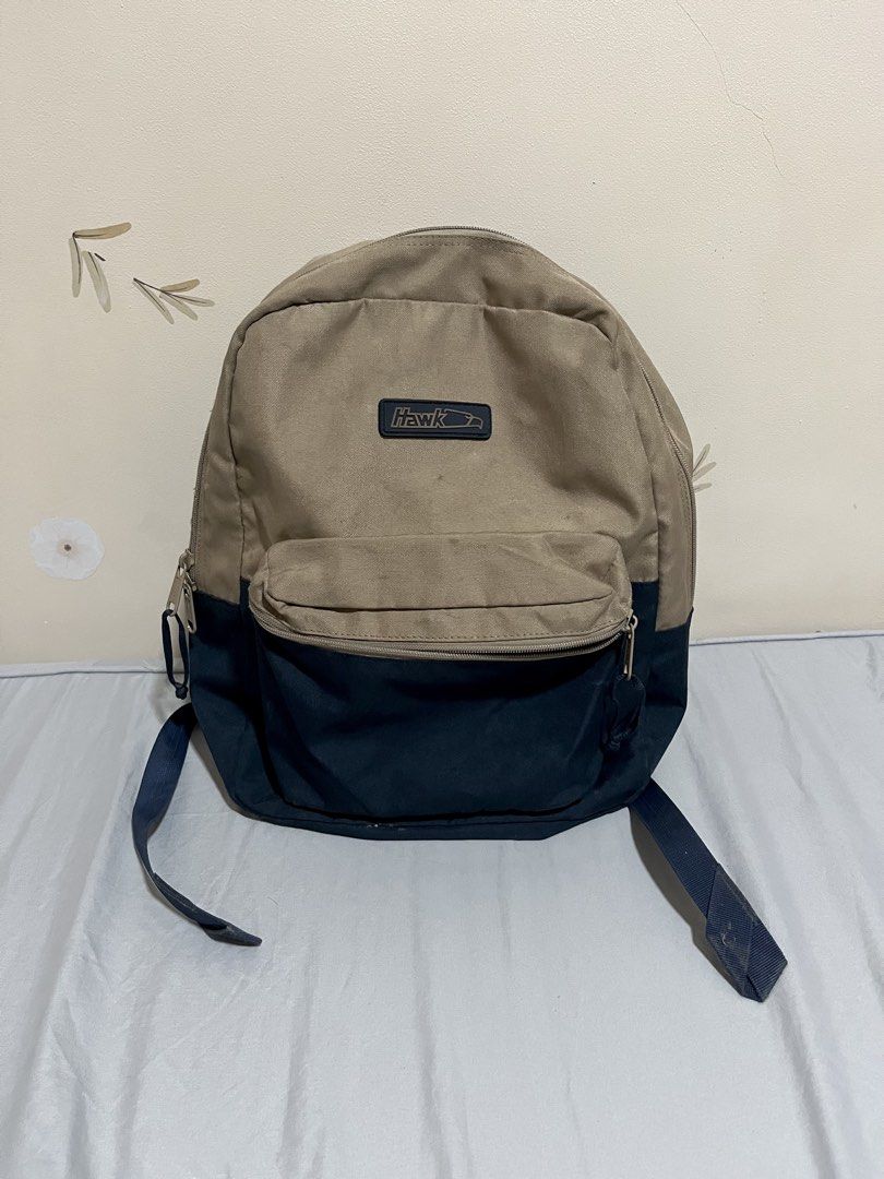 Hawk Backpack Tan and Navy Blue (Category: Backpacks) located in Manila. Submitted by p1nkbaddi3 (Listing ID 1444995690, Image 1). Description: Needs Cleaning only - Classic Hawk backpack - Tan and navy blue colorway - Two main compartments - Front zip pocket - Adjustable shoulder straps - Ideal for school or everyday use - Shows some signs of wear, but still functional 📍Location: Valenzuela City 💰Payment Method: Payment first via Gcash or bank