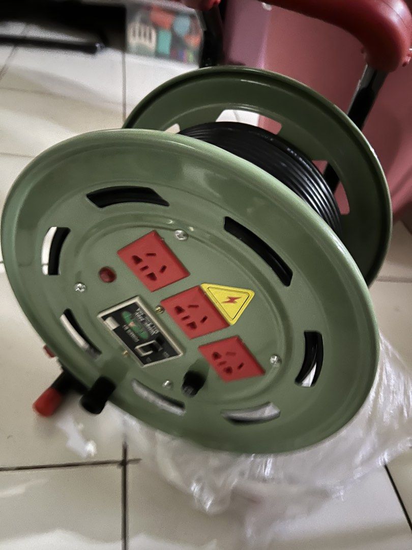 Heavy Duty Extension Cord Reel with Multiple Sockets (Category: Electrical, Adaptors & Sockets) located in Quezon City. Submitted by sjlsrolling (Listing ID 1444954978, Image 2). Description: - Extension cord reel with 3 universal sockets - Max capacity: 30A, 220V - Built-in power switch and indicator light - Perfect for workshops and outdoor use - Cable neatly wound on reel - Red handle for easy carrying - Durable green casing.