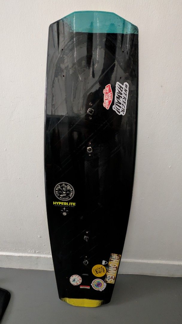 Hyperlite Wakeboard (Category: Water Sports) located in Singapore. Submitted by mixednut (Listing ID 1444972748, Image 1). Description: - Used Hyperlite wakeboard - Color: Black with teal and yellow accents - Condition: Shows scuffs and chips on edges from use, but still has plenty of life left - Features: Stickers on the bottom - Ready for immediate use on the water.