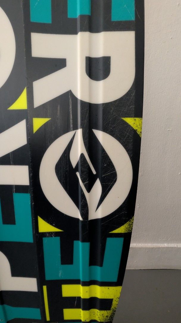 Hyperlite Wakeboard (Category: Water Sports) located in Singapore. Submitted by mixednut (Listing ID 1444972748, Image 4). Description: - Used Hyperlite wakeboard - Color: Black with teal and yellow accents - Condition: Shows scuffs and chips on edges from use, but still has plenty of life left - Features: Stickers on the bottom - Ready for immediate use on the water.