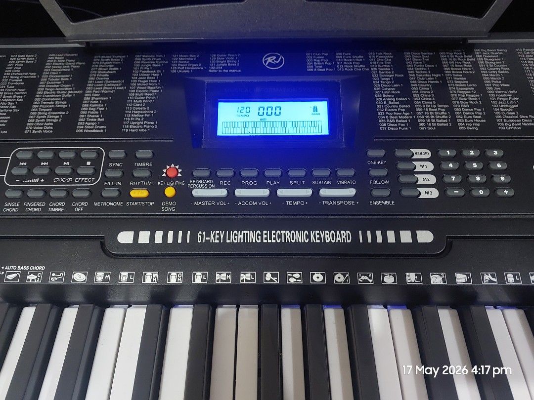 K-7700 Electronic Keyboard (Category: Computer Keyboard) located in Makati City. Submitted by grande.taille.by.ab (Listing ID 1438389965, Image 3). Description: - Electronic keyboard with built-in music stand - Features a display screen and function buttons - Full set of white and black keys - Built-in speakers - Model number visible.