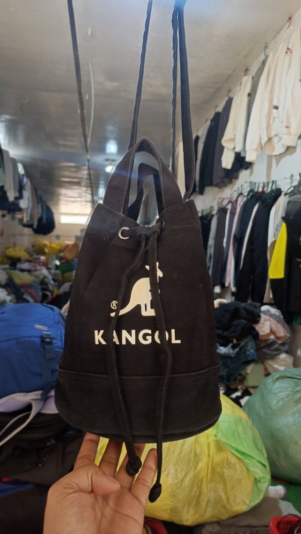Kangol Black Canvas Bucket Bag (Category: Cross-body Bags) located in Buenavista. Submitted by judymaejap13177 (Listing ID 1444879243, Image 1). Description: - Authentic Kangol black canvas bucket bag - Iconic kangaroo logo and brand name detail - Secure drawstring closure - Convenient inner pocket - Sturdy round base - Ideal for everyday wear and tear.