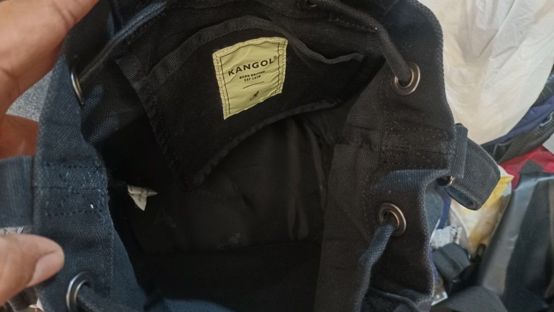 Kangol Black Canvas Bucket Bag (Category: Cross-body Bags) located in Buenavista. Submitted by judymaejap13177 (Listing ID 1444879243, Image 3). Description: - Authentic Kangol black canvas bucket bag - Iconic kangaroo logo and brand name detail - Secure drawstring closure - Convenient inner pocket - Sturdy round base - Ideal for everyday wear and tear.