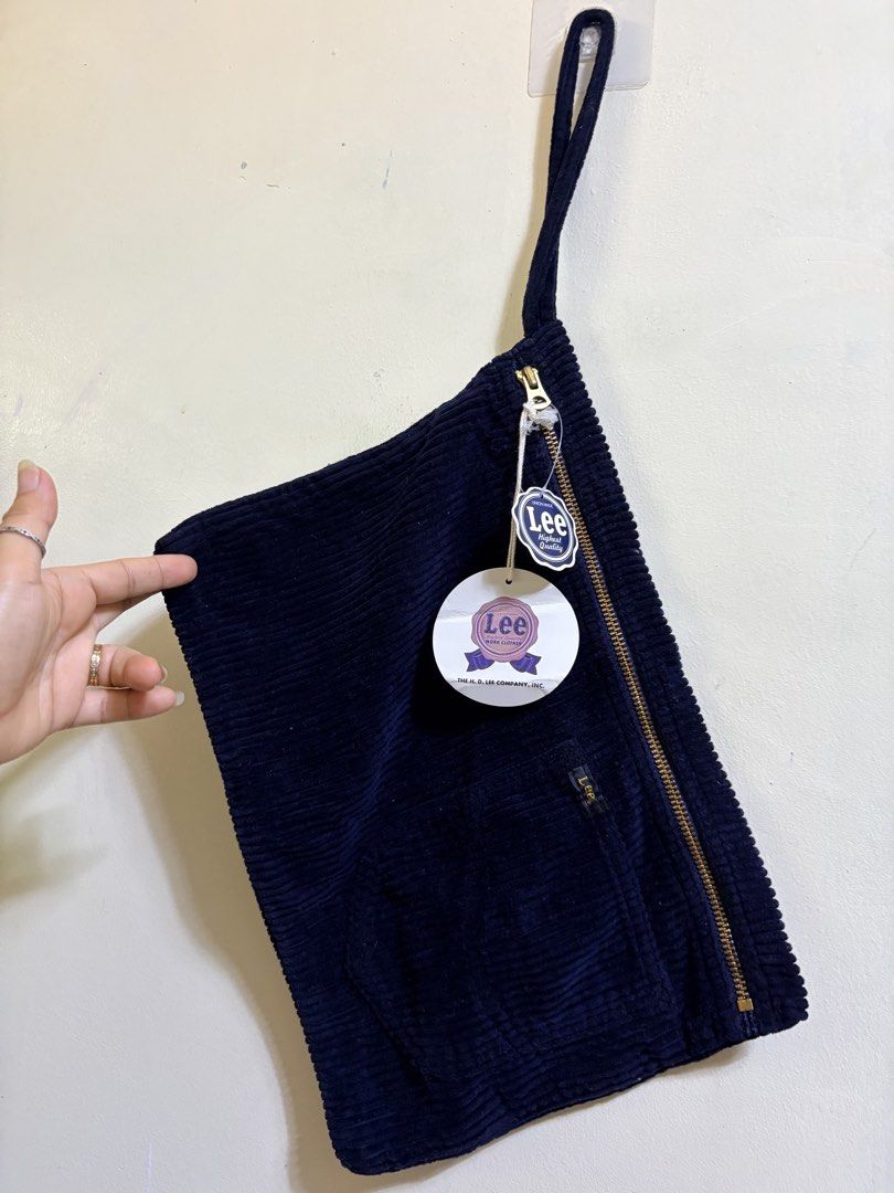 Lee Corduroy Pouch Bag Navy Blue (Category: Purses & Pouches) located in Paete. Submitted by skydruemadison (Listing ID 1444890484, Image 1). Description: - Brand: Lee - Color: Navy Blue - Material: Corduroy - Closure: Zip -14x10 - Features: Small front pocket - Condition: Brand new with original tags attached - Use: Ideal for organizing essentials.