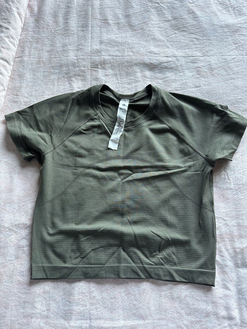 Lululemon Short Sleeve Athletic Top - Olive Green (Category: Activewear) located in Muntinlupa City. Submitted by stuffbya (Listing ID 1444872511, Image 1). Description: - Olive green Lululemon short sleeve top - Textured fabric - Raglan sleeves for easy movement - Crew neck - Size: 6 - Ideal for workouts or casual wear.