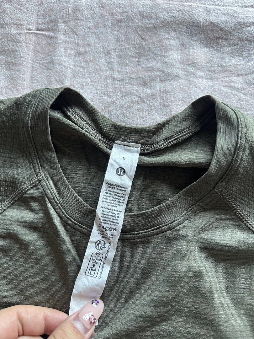 Lululemon Short Sleeve Athletic Top - Olive Green (Category: Activewear) located in Muntinlupa City. Submitted by stuffbya (Listing ID 1444872511, Image 2). Description: - Olive green Lululemon short sleeve top - Textured fabric - Raglan sleeves for easy movement - Crew neck - Size: 6 - Ideal for workouts or casual wear.