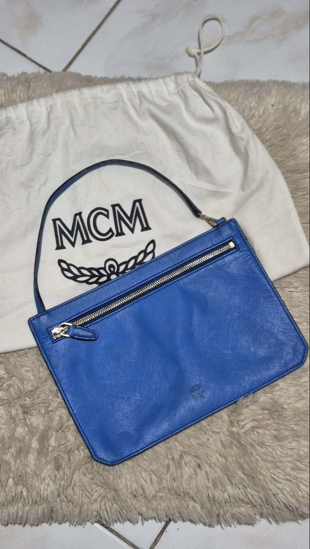 MCM Clutch Bag (Category: Luxury Bags & Wallets) located in Davao. Submitted by kluxfinds (Listing ID 1444986098, Image 1). Description: Issue: Very minor glazing separation on the strap/side lining ,only visible upon close inspection .