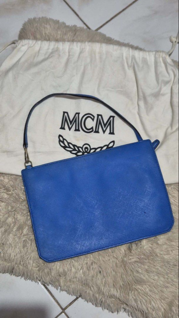 MCM Clutch Bag (Category: Luxury Bags & Wallets) located in Davao. Submitted by kluxfinds (Listing ID 1444986098, Image 2). Description: Issue: Very minor glazing separation on the strap/side lining ,only visible upon close inspection .