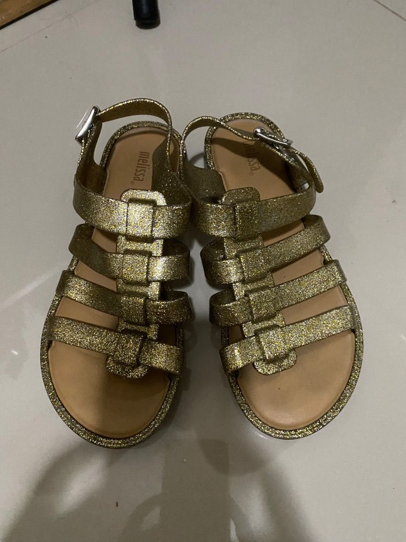 Melissa Gold Glitter Jelly Sandals (Category: Flats & Sandals) located in Angeles City. Submitted by raintree.lorenzo (Listing ID 1444972630, Image 1). Description: - Melissa gold glitter sandals - Gladiator style with multiple straps - Secure buckle closure - Sparkly and fun for any occasion - Great for summer days.