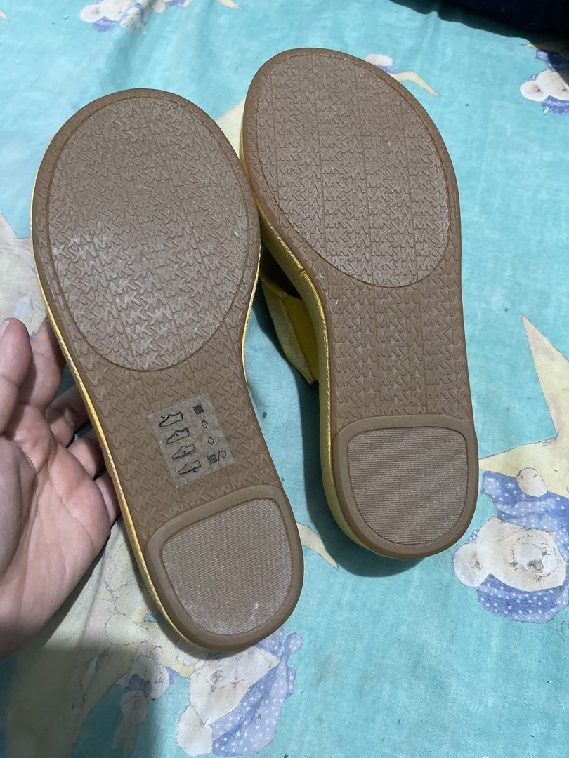 Michael Kors Yellow MK Logo Platform Wedge Sandals (Category: Wedges) located in Manila. Submitted by edensy (Listing ID 1445035736, Image 2). Description: - Yellow Michael Kors platform sandals - Features iconic MK logo pattern on straps - Comfortable wedge heel for added height - Easy slip-on design mild flaws hardly notice - Ideal for casual outings and everyday wear.