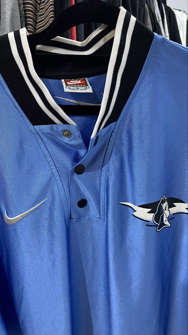 Nike Ducks Light Blue Basketball Jersey (Category: Activewear) located in Porac. Submitted by moethrifter (Listing ID 1444949616, Image 2). Description: - Light blue Nike jersey - 'Ducks' graphic on the back - Nike swoosh logo - NBA logo patch on sleeve - Button-up neckline - Striped collar - Ideal for Ducks fans and basketball lovers.