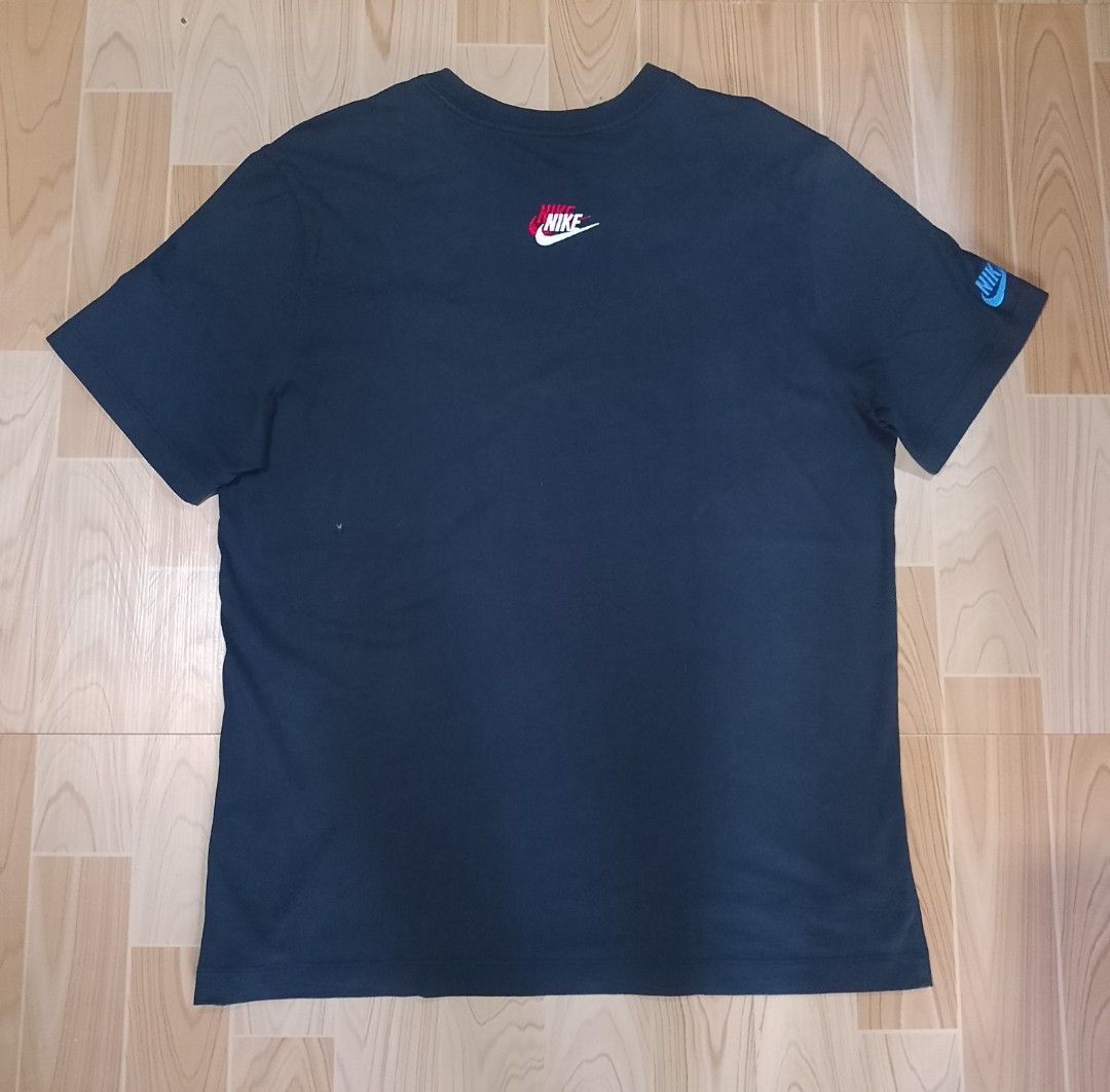 Nike T-shirt with embroidered logos (Category: Tshirts & Polo Shirts ) located in San Jose del Monte. Submitted by azetor (Listing ID 1444874010, Image 2). Description: - Classic black Nike t-shirt - Embroidered Nike logos on chest and sleeve - Chest logo features layered red, blue, and white stitching - Sleeve logo is a vibrant blue - Small yellow Nike Swoosh detail on the hem - Ideal for everyday casual wear - size XL on tags - measurements - c