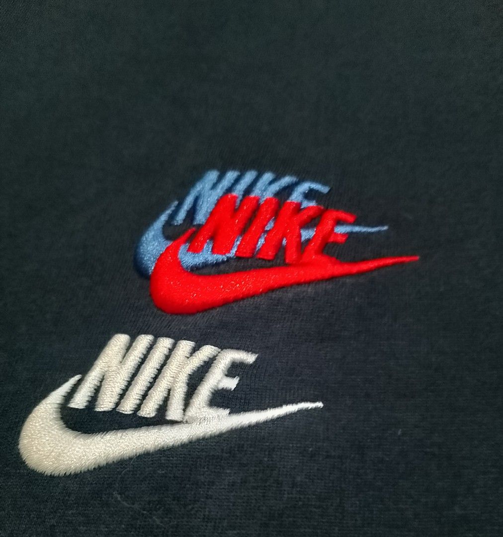 Nike T-shirt with embroidered logos (Category: Tshirts & Polo Shirts ) located in San Jose del Monte. Submitted by azetor (Listing ID 1444874010, Image 3). Description: - Classic black Nike t-shirt - Embroidered Nike logos on chest and sleeve - Chest logo features layered red, blue, and white stitching - Sleeve logo is a vibrant blue - Small yellow Nike Swoosh detail on the hem - Ideal for everyday casual wear - size XL on tags - measurements - c