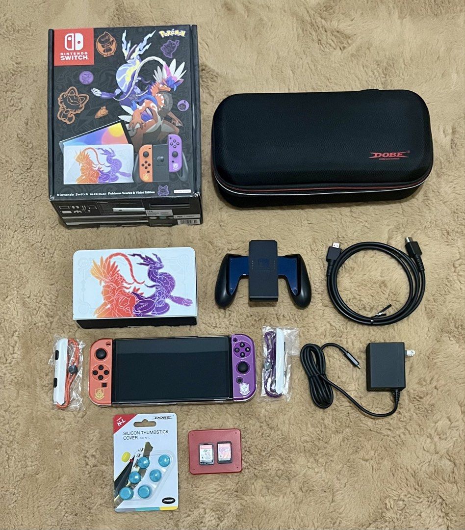Nintendo Switch - OLED Model: Pokémon Scarlet & Violet Edition (Category: In-Game Products) located in Lipa City. Submitted by ShopAtFirstSight (Listing ID 1445030396, Image 1). Description: Includes: Games - Nintendo Switch Super Mario Bros Wonder (MDE) + Nintendo Switch NBA 2K24 (w/ Storage box for game cards) Dobe Carrying Case Storage Bag Nintendo Switch - OLED Model Console (Special design) w/ Protection Case Joy-Con (L)/(R) controllers (spe