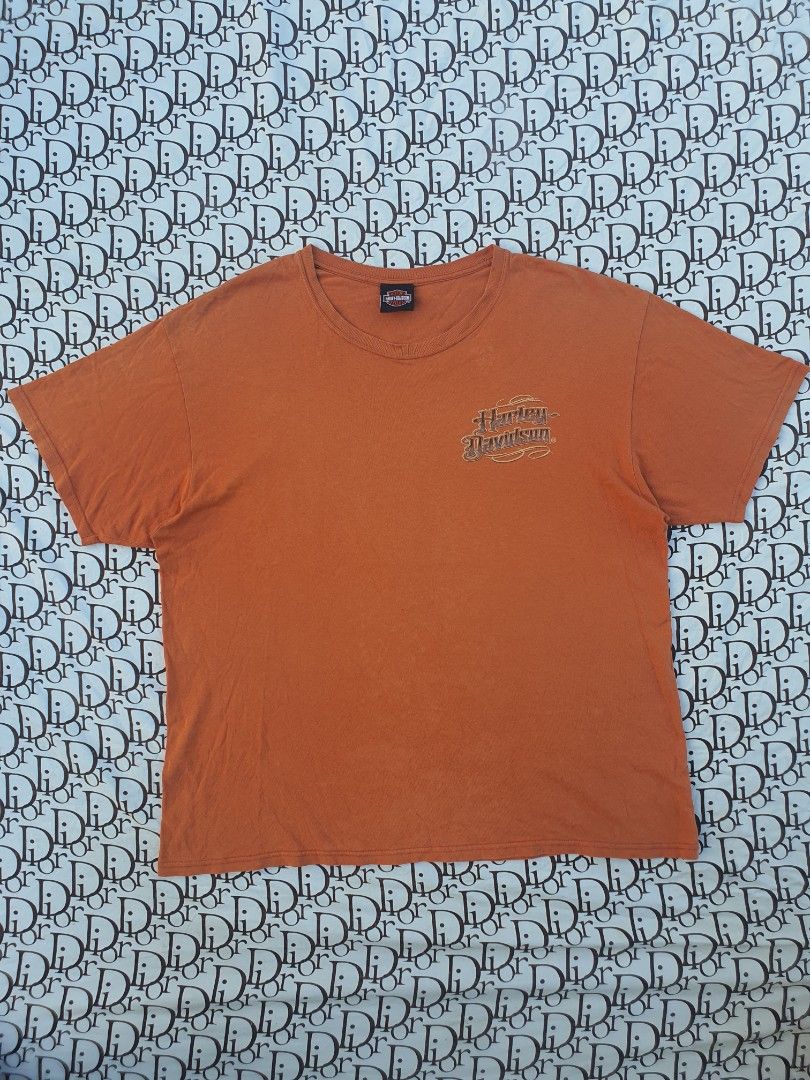 Orange Harley Davidson T-Shirt with Eagle Graphic (Category: Tshirts & Polo Shirts ) located in San Fernando. Submitted by retro.district. (Listing ID 1445025193, Image 2). Description: - Orange Harley Davidson T-Shirt - Features a large eagle graphic with flames and 'Performance Parts' text - Classic Harley Davidson logo on the front chest - Made from comfortable cotton material - Perfect for any Harley Davidson fan - Ready for its new owner.
