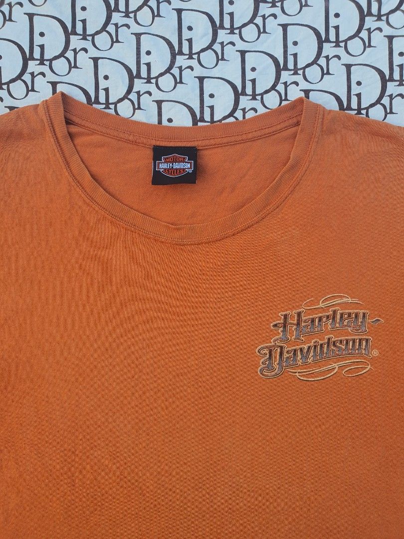 Orange Harley Davidson T-Shirt with Eagle Graphic (Category: Tshirts & Polo Shirts ) located in San Fernando. Submitted by retro.district. (Listing ID 1445025193, Image 3). Description: - Orange Harley Davidson T-Shirt - Features a large eagle graphic with flames and 'Performance Parts' text - Classic Harley Davidson logo on the front chest - Made from comfortable cotton material - Perfect for any Harley Davidson fan - Ready for its new owner.