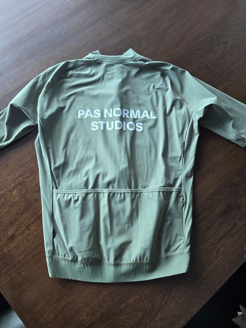 Pas Normal Studios Cycling Jacket - Olive Green (Category: Activewear) located in Quezon City. Submitted by mr.stealdeal (Listing ID 1445017417, Image 2). Description: - Pas Normal Studios cycling jacket - Color: Olive Green - Lightweight and breathable material - Long sleeves with elasticated cuffs - Elasticated hem - Full zip front closure - Three convenient pockets on the back - Ideal for cycling and outdoor rides.