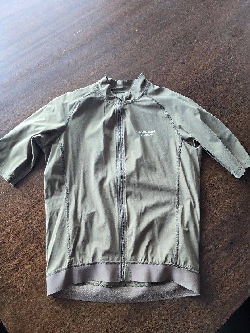 Pas Normal Studios Cycling Jacket Khaki Green (Category: Activewear) located in Quezon City. Submitted by mr.stealdeal (Listing ID 1445017543, Image 1). Description: - Pas Normal Studios cycling jacket - Color: Khaki Green - Full zip front closure - Three rear pockets for storage - Elasticated cuffs and hem for a snug fit - Ideal for cycling and outdoor rides - Please check photos for condition details.