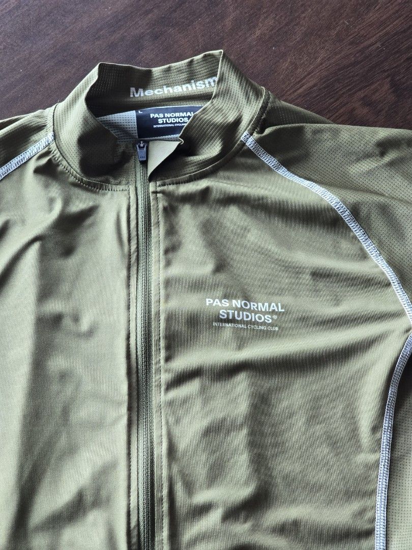 Pas Normal Studios Mechanism Cycling Jersey - Olive Green (Category: Activewear) located in Quezon City. Submitted by mr.stealdeal (Listing ID 1445015046, Image 2). Description: - Pas Normal Studios Mechanism cycling jersey - Color: Olive green with white contrast stitching - Full zip front - Three back pockets - Features PN S logo on the back - Ideal for cycling.