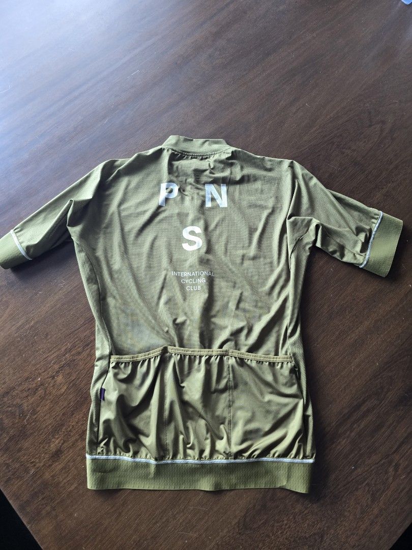 Pas Normal Studios Mechanism Cycling Jersey - Olive Green (Category: Activewear) located in Quezon City. Submitted by mr.stealdeal (Listing ID 1445015046, Image 3). Description: - Pas Normal Studios Mechanism cycling jersey - Color: Olive green with white contrast stitching - Full zip front - Three back pockets - Features PN S logo on the back - Ideal for cycling.